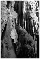 Tourist framed by cave formations, upper cave, Phong Nha Cave. Vietnam ( black and white)