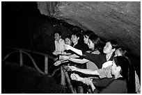 Women catch the water seeping from Tan Thanh Cave, said to have mirculous properties. Lang Son, Northest Vietnam (black and white)