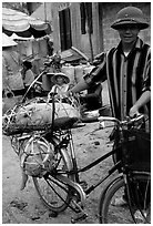 Man with a newly bought pig loaded on his bicycle, That Khe market. Northest Vietnam ( black and white)