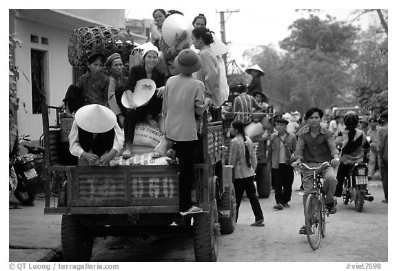 Riding in the back of an overloaded truck. Northest Vietnam (black and white)