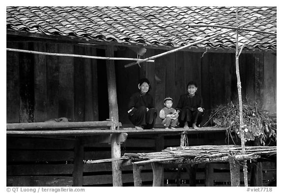 Women and child of the Nung ethnicity in front of their home. Northeast Vietnam