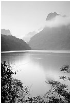 Morning mist on the tall cliffs surrounding Ba Be Lake. Northeast Vietnam ( black and white)