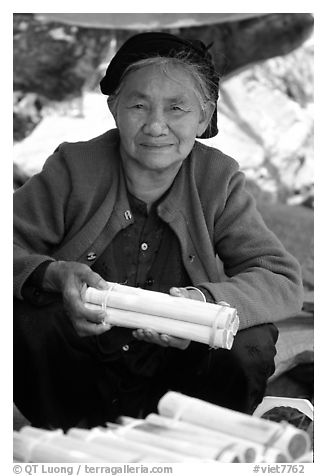 Woman selling sweet rice cooked in bamboo tubes. Vietnam