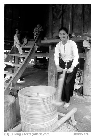 Woman of the Thai ethnicity milling grain, near Mai Chau. Northwest Vietnam