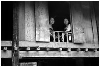 Two thai women at the window of their stilt house, Ban Lac village. Northwest Vietnam ( black and white)