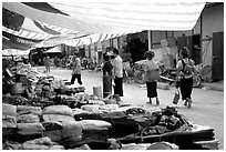 Thai women walk in a town market, near Son La. Northwest Vietnam ( black and white)
