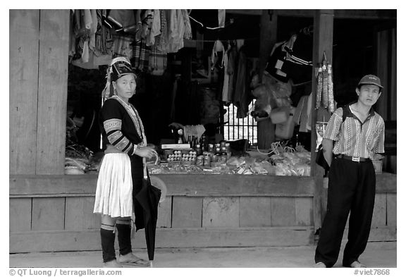 Man and montagnard woman in front of a store, near Lai Chau. Northwest Vietnam