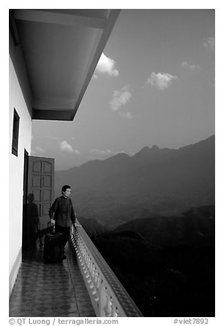 Traveler on a hotel balcony, looking at the Hoang Lien Mountains. Sapa, Vietnam