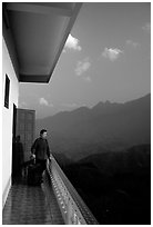 Traveler on a hotel balcony, looking at the Hoang Lien Mountains. Sapa, Vietnam ( black and white)