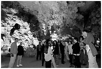 Tourists in illuminated cave. Halong Bay, Vietnam (black and white)
