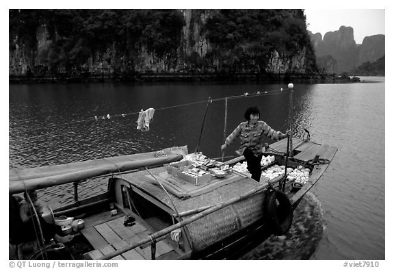 Peddling from a boat. Halong Bay, Vietnam (black and white)