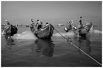 Fishermen get their nets out of their small fishing boats. Vung Tau, Vietnam ( black and white)