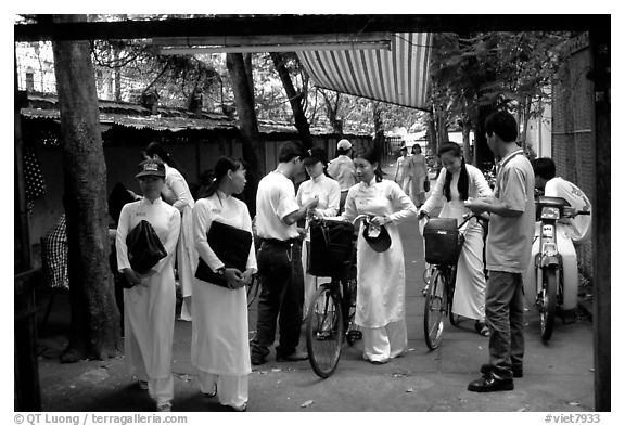 Uniformed school girls exit school. Ho Chi Minh City, Vietnam (black and white)