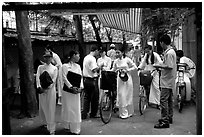 Uniformed school girls exit school. Ho Chi Minh City, Vietnam ( black and white)
