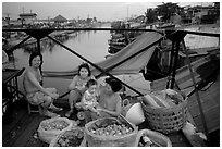 Family selling fruit on a bridge. Cholon, Ho Chi Minh City, Vietnam ( black and white)