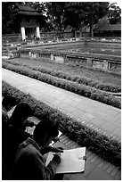 Art students drawing in the Temple of the Litterature. Hanoi, Vietnam ( black and white)