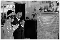 Newly-wed couple prays at the groom's ancestral altar. Ho Chi Minh City, Vietnam ( black and white)