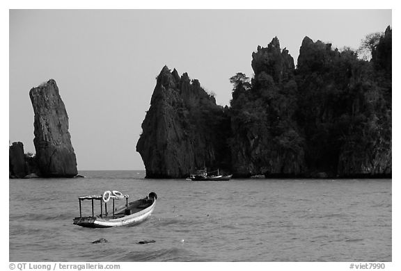 Small boats and offshore rock formations. Hong Chong Peninsula, Vietnam