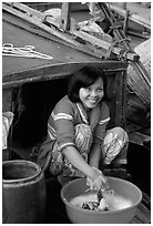 Woman doing laundry on live-aboard boat, the cheapest and most convenient housing in the Delta, near Can Tho. Vietnam ( black and white)