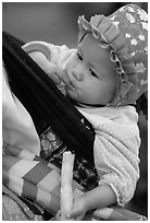Baby enjoying sugar cane, the natural lollypop,  Bac Ha. Vietnam (black and white)