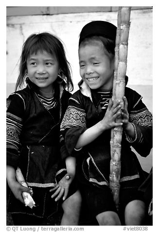 Black Hmong girls, with their daily fix of sugar cane, Sapa. Vietnam