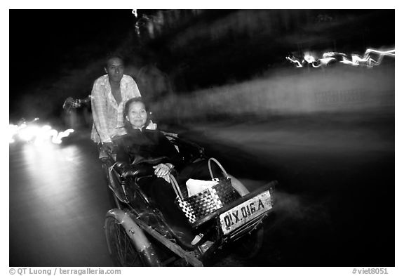 Enjoying the freshness of the night during a cyclo ride. Ho Chi Minh City, Vietnam (black and white)