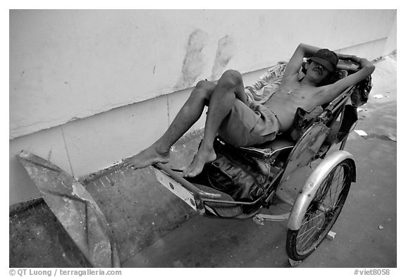 Cyclo driver taking an afternoon nap. Ho Chi Minh City, Vietnam (black and white)