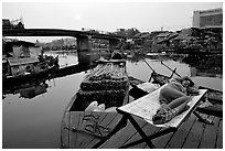 Sleeping out for the fresh air. Morning near the Saigon arroyo. Cholon, Ho Chi Minh City, Vietnam ( black and white)