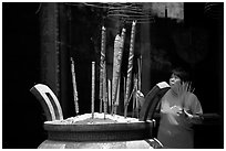Offering incense at a Chinese temple in Cho Lon. Cholon, District 5, Ho Chi Minh City, Vietnam (black and white)