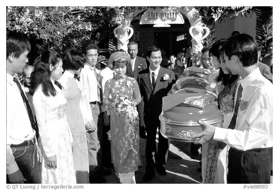 Exchange of gifts at wedding, upon exiting bride's home. The bride traditionaly wears red. Ho Chi Minh City, Vietnam