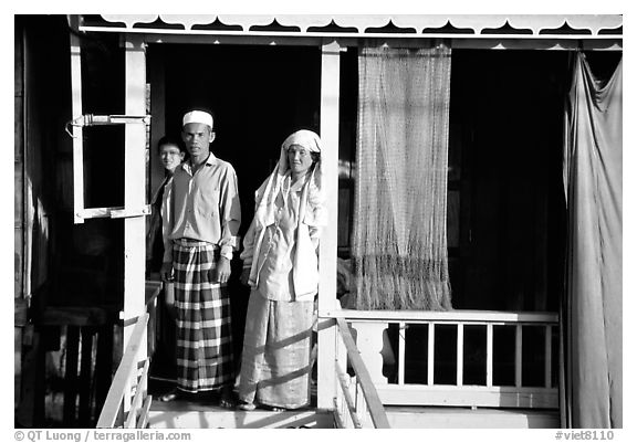 Muslem family outside stilt house in Cham minority village. Chau Doc, Vietnam (black and white)