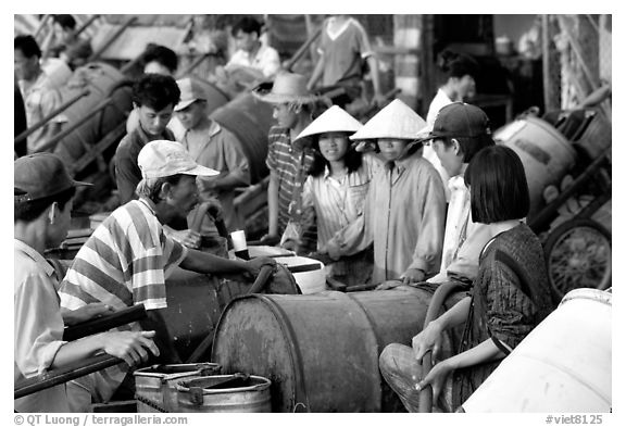 Filling up water tanks for the day. Ha Tien, Vietnam (black and white)