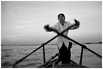 Woman using the X-shaped  paddle characteristic of the Delta. Can Tho, Vietnam ( black and white)
