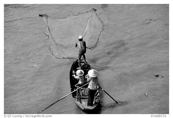 Fisherman casting net seen from above. Can Tho, Vietnam (black and white)