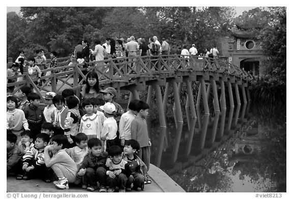 School children at The Huc bridge, Hoan Kiem lake. Hanoi, Vietnam (black and white)