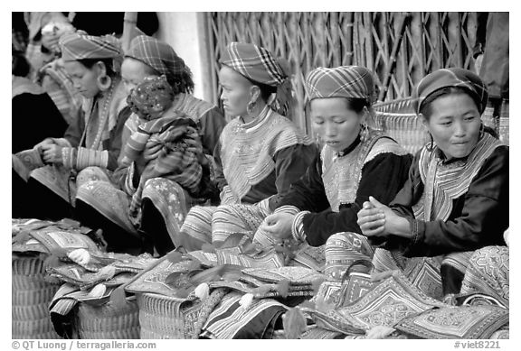 Women sell the colorful garnments after which the Flower Hmong are named. Bac Ha, Vietnam (black and white)