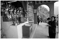 Praying at an outdoor temple. Perfume Pagoda, Vietnam ( black and white)