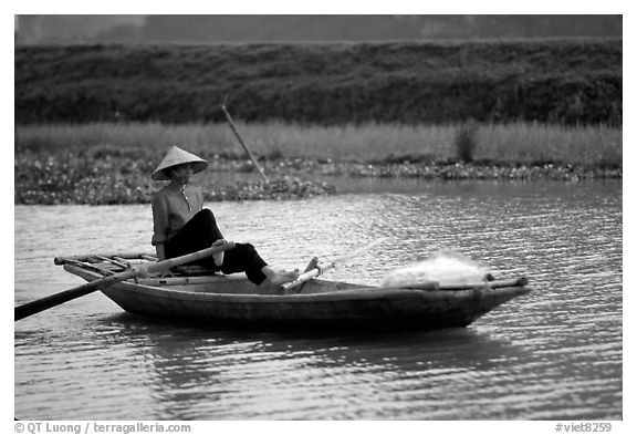 The local technique of paddling with feet, Ken Ga canal. Ninh Binh,  Vietnam