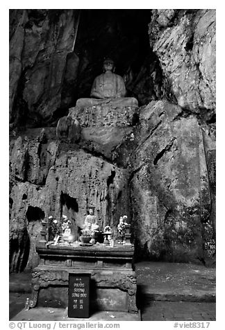Altar and Buddha statue in a troglodyte sanctuary of the Marble Mountains. Da Nang, Vietnam (black and white)