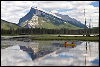 Canoe and Mt Rundle reflection in first Vermillion Lake, afternon. Banff National Park, Canadian Rockies, Alberta, Canada (color)