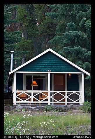 Cabin in the woods with interior lights. Banff National Park, Canadian Rockies, Alberta, Canada