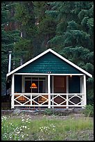 Cabin in the woods with interior lights. Banff National Park, Canadian Rockies, Alberta, Canada