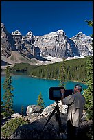 Photographer operating a 8x10 view camera at Moraine Lake. Banff National Park, Canadian Rockies, Alberta, Canada ( color)