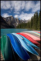 Colorful canoes stacked on the boat dock, Lake Moraine, morning. Banff National Park, Canadian Rockies, Alberta, Canada