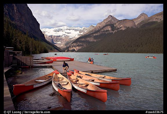 Red canoes at boat dock, Lake Louise, morning. Banff National Park, Canadian Rockies, Alberta, Canada (color)