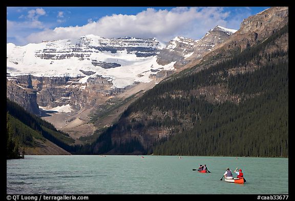 Canoes, Victoria Peak, and blue-green glacially colored Lake Louise, morning. Banff National Park, Canadian Rockies, Alberta, Canada