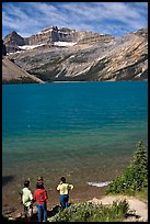 Family standing on the shores of Bow Lake. Banff National Park, Canadian Rockies, Alberta, Canada (color)
