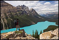 Hiker standing on a rock overlooking Peyto Lake. Banff National Park, Canadian Rockies, Alberta, Canada ( color)
