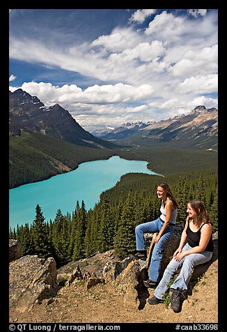 Women sitting on a rook overlooking Peyto Lake. Banff National Park, Canadian Rockies, Alberta, Canada