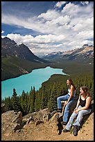 Women sitting on a rook overlooking Peyto Lake. Banff National Park, Canadian Rockies, Alberta, Canada (color)